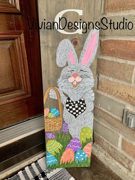 This spring Easter themed porch leaner is handmade and handpainted as well as sealed against outdoor weather conditions. It’s beautiful for the entrance of any home. The dimensions are 60x9.25x1. Spring Pallet Ideas, Barn Board Crafts, Easter Front Porch Decor, Porch Boards, Easter Wood Signs, Easter Porch, Easter Paintings, Easter Wood Crafts, Easter Door Hanger