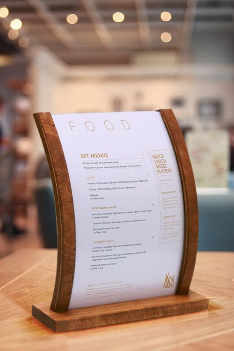 Curved wooden menu stand holding tabletop sign Counter Signage, Table Menu Stand, Wooden Menu Stand, Shish Taouk, Table Signage, Menu Stand, Point Of Sale Display, Wooden Display Stand, Signage Display