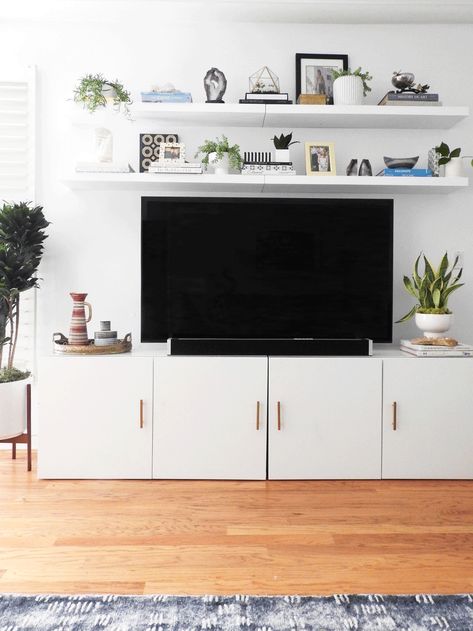 Biggest decorating challenge: decorating around the TV. Here's 40 great tips to disguise the TV, hide it altogether, or simply give it a quick style fix to make it look less intrusive. #decorating #TV Shelf Above Tv, Tv Stand Minimalist, Ikea Tv Stand, Lack Shelf, Besta Ikea, Ruang Tv, Ikea Tv, Tv Stand Decor, Flat Screen Tv