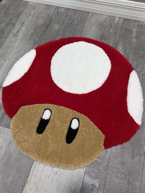 Introducing our handmade Mario Mushroom floor rugs featuring a no-slip backing! These amazing rugs are the perfect addition to any home décor, adding warmth, comfort, and style to your living space. Crafted with care and attention to detail, our rugs are made using high-quality materials that are both durable and soft underfoot. The tufted design creates a plush, luxurious texture that feels great to walk on and adds a cozy, welcoming touch to any room. Measuring 22.5 inches by 22.5 inches (57.15 cm by 57.15 cm), this rug is the ideal size for placing in front of a door, bed, or fireplace, or using as a focal point in your living room or bedroom. Your choice of color scheme makes it easy to blend seamlessly with your existing décor, while the unique design adds a touch of fun and personali Fun Rugs Bedroom, Rug Tufting Ideas Easy, Rug Tufting Design, Rug Tufting Ideas, Fluffy Rugs Bedroom, Turf Rug, Comfy Room Ideas, Rug Tuft, Toad Mario