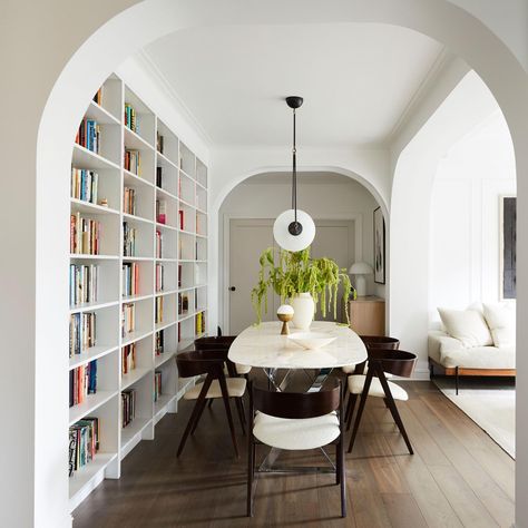 Dining table next to a wall of bookshelves in a renovated prewar apartment full of archways, Brooklyn, New York City [3275×3275] - Imgur Dining Room Library, Home Library Design, Wall Bookshelves, Home Libraries, New York Apartment, Built In Bookcase, Plywood Furniture, The Dining Room, Stunning Interiors