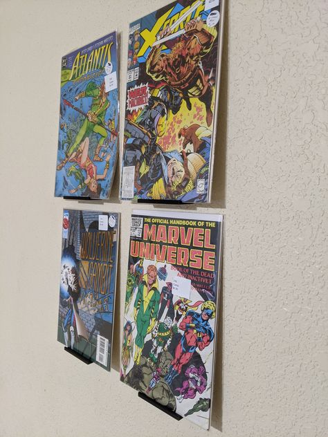 "Display your most prized comics with these floating shelf units Easy installation and very sturdy! Choose between Screw mounted and tape mounted! NEW Added optionality for command style. these are an improvement over the regular tape mounting variety as they easily remove damage free (just pull the tab) After removal you can purchase \" large command strip refill\" to replace the wall stick layer. slim version is great for holding bare comics upright wide version gives more space for comics in Display Comic Books, Comic Book Wall Display, Comic Book Wall, Comic Storage, Comic Display, Diy Wall Decor Ideas, Comic Book Display, Comic Room, Book Display Stand