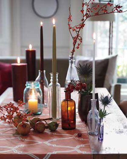 Various sized candles in an excletic assortment of glass elements. From 25 Ways to Decorate with Candles - The Cottage Market. Bottle Centerpieces, Bright Decor, Creative Candles, Autumn Table, Bottle Candles, Tall Candle, Candle Displays, Trash To Treasure, Empty Bottles