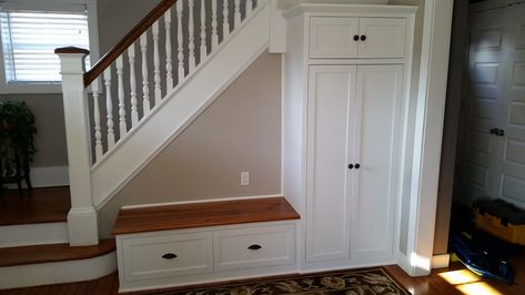 Customer was looking for a way to utilize empty space near the front door.  A combination storage bench and cabinet was designed to fit in under the stairs.  The tall cabinet has a large open space with hooks for storing kids' jackets and school backpacks, along with upper and lower storage for smaller items.  The bench provides additional storage via a flip-up top.  The top was made from reclaimed heart pine and was stained/finished to match the existing floors. Shoe Storage Cabinet With Doors, Under Stairs Nook, Room Under Stairs, Space Under Stairs, Stairs In Kitchen, Stairs Renovation, Entry Storage, Bench Entryway, Stairs Makeover