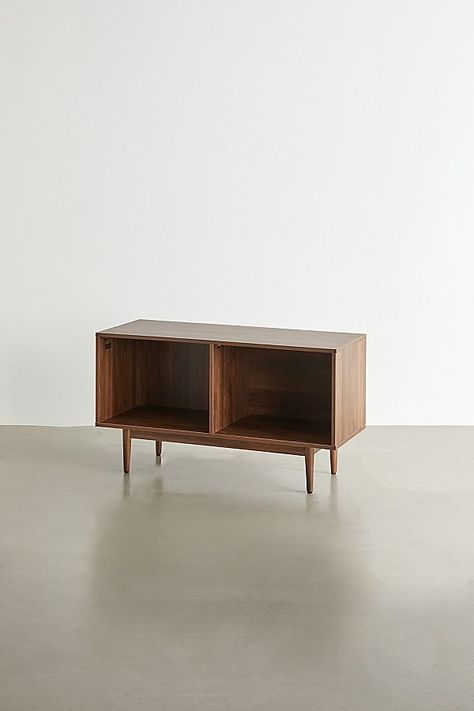 A simple yet stunning storage console, elevate your space with this multi-sectioned console with statement finishes and tapered legs for a mid-century feel. Perfect for storing your vinyl, record player, gaming consoles and more. Features Mid-century storage console from Crosley Multiple compartments offer versatile storage options Tapered legs Sized to fit full-size 12-inch records Holds up to 120 single LPs Versatile - use it to store your vinyl, gaming consoles, books and more Assembly requir Vinyl Console, Mid Century Storage, Storage Console, Record Table, Vinyl Record Player, Record Storage, Record Player, Cubbies, Particle Board