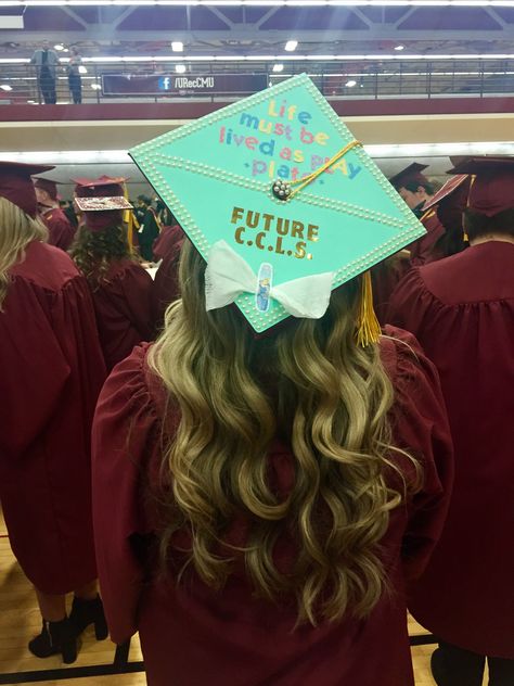 Tiffany's Themed Child Life Graduation Cap - "Life must be lived as play" - Plato  - Future CCLS -  bow made with gauze and a cinderella bandaid Child Development Graduation Cap, Grad Cap Ideas, Masters Graduation, College Graduation Cap Decoration, Child Life Specialist, Grad Cap Designs, College Graduation Pictures, Grad Caps, Cap Decoration