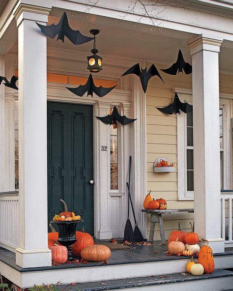 Made out of craft paper, these fluttering winged critters are a great way to welcome trick-or-treaters in hair-raising style by turning your front porch into a bat cave. #marthastewart #halloween #halloweendecor #diyideas #diyhalloween Porche Halloween, Diy Halloween Dekoration, Halloween Decor Diy, Casa Halloween, Halloween Front Porch Decor, Diy Front Porch, Diy Halloween Decor, Halloween Flowers, Halloween Porch Decorations