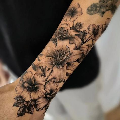 90 Awesome Lily Tattoo Designs with Meaning | Art and Design Black Lily Tattoo Cover Up, Hibiscus And Lily Flower Tattoo, Hibiscus And Lily Tattoo, Mens Lily Tattoo, Lily Sleeve Tattoos For Women, Lilly Tattoo For Men, Lilly Tattoo Men, Black And White Lily Tattoo, Lily Tattoo Men