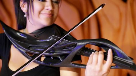 Monad Studio Two-String Piezoelectric ViolinBlurring the line between art and tech, Miami-based design firm Monad Studio conceived this sleek, futuristic 3-D–printed two-string violin in collaboration with artist-musician Scott F. Hall as part of a series for a sonic art installation. Despite its decidedly sculptural alien aesthetic, the instrument is, at its core, still a violin, though it eschews the traditional four strings for two, relying largely on the piezoelectric effect to create its be Violin Pics, Violin Design, Electric Violin, Alien Aesthetic, 3d Printed Objects, Gloves Design, Music Heals, Sonic Art, Architectural Digest