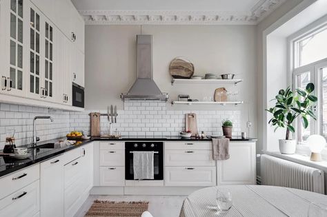 A white kitchen with black countertops and a tile backsplash Behind Stove Backsplash Ideas, White Kitchen With Black Countertops, Stove Backsplash Ideas, Kitchen With Black Countertops, Behind Stove Backsplash, Post In Kitchen, Stainless Steel Kitchen Backsplash, Black Kitchen Countertops, Stove Backsplash