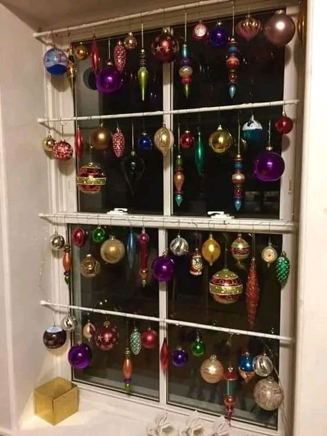 Christmas Ornament Window Display, Window Ornaments Ideas, Ornaments Hanging In Window, Hanging Ornaments In Windows, Ornaments In Window, Window Garland Christmas, Window Decoration Ideas, Window Garland, Merry Chrysler