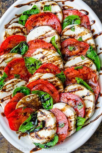 Caprese Salad is an easy, classic Italian recipe. Ripe tomatoes, fresh mozzarella and basil are a winning combination and you will love the balsamic glaze on this Caprese Salad Recipe! #natashaskitchen #caprese #capresesalad #capresesaladrecipe #salad #tomatosalad Salad Caprese, Tomatoes And Mozzarella, Caprese Salad Recipe, Fresh Tomato Recipes, Salad Recipes Video, Italian Dinner, Cooking Classy, Balsamic Glaze, Tomato Recipes