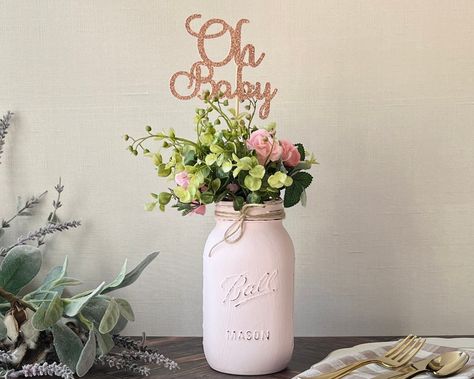 Oh Baby Topper on a Quart Size Pink Mason Jar with Artificial Flowers Mason Jar Centerpieces Purple, Baby Shower Simple Centerpieces, Girl Baby Shower Table Centerpieces, Mason Jar Baby Shower Centerpieces, Dollar Tree Baby Shower Centerpieces, Baby In Bloom Table Decor, Baby Shower Centerpieces Girl, Centerpieces For Baby Shower, February Baby Showers