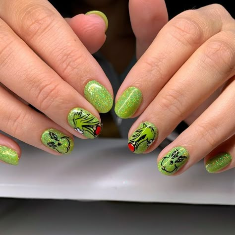 These short, glittery green nails are adorned with playful Grinch illustrations, offering a fun yet understated way to embrace the holiday spirit. The shimmery finish adds a touch of festive glam perfect for any Christmas occasion. Green Grinch Nails, Glittery Green Nails, Grinch Nail Designs, Easy Christmas Ideas, Grinch Faces, Grinch Nails, Natural Acrylic Nails, Natural Nail Art, Gel Natural