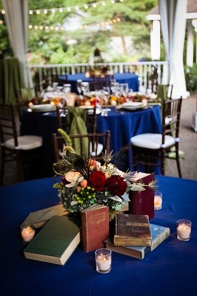 Medieval Centerpieces Wedding, Hanging Book Page Decorations, D&d Wedding Theme, Book Centrepiece Wedding, Literary Wedding Theme, Fall Jewel Tones, Vintage Book Centerpiece, Book Theme Wedding, Book Wedding Centerpieces