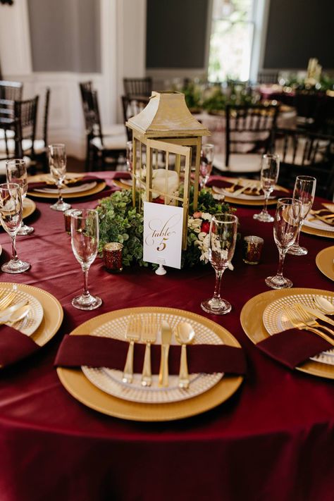 Venue: Richwood on the River | Burgundy wedding table setting; gold accents; burgundy and gold wedding; centerpieces. Terracotta Burgundy Gold Wedding, Burgundy Cream And Gold Wedding Decor, Maroon White Gold Wedding, Burgundy Gold Table Setting, Cabernet And Gold Wedding, Burgundy Decorations Quinceanera, Red White And Gold Wedding Centerpieces, Burgundy And Gold Table Setting, Burgundy And Gold Decor