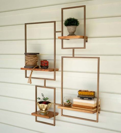 The luminous matte gold finish sets off the chic contemporary frame design of this wall shelf. Position your favorite knickknacks, succulent plants or books on the four wood surfaces for a look that's all your own. The gold metal frame outlines the shelf like a window box and the salvaged wood plank shelves are left natural for a refined yet weathered look. This large-scale shelving unit makes a beautiful showstopper in your entry wall or living room. V5419,Gold Statement Shelves, Wood Plank Shelves, Wall Mounted Shelving Unit, Wall Unit Designs, Wall Shelf Unit, Tiered Shelf, Wall Shelving Units, Wall Shelving, Metal Shelving Units