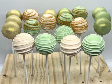 Gold And Green Theme Party, Green And Gold Gender Reveal Party, Sage Green And Gold Cake Pops, Princess Tiana Desserts, Light Green Cake Pops, Sage Green And Gold Dessert Table, Sage Green And White Cake Pops, Green Candy Table Ideas, Forest Green Cupcakes