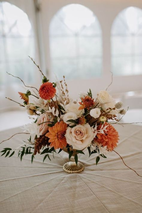 Centerpiece Inspiration: 1/2 tables with small/medium centerpieces; 1/2 tables with 3-5 small bud vases & candles Boho Fall Wedding Florals, Floral Arrangements For Fall Wedding, Rust Orange Floral Arrangement, Terracotta Flowers Wedding Table, Floral Arrangements Fall Wedding, Fall Boho Wedding Flowers Centerpieces, Wedding Florals Terracotta, Wedding Flower Arrangements Bouquets, Fall Color Centerpieces Wedding