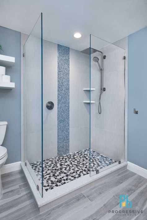 The large open shower features: -An Emser Cultura pebble tile floor -An American Olean Herringbone vertical tile accent wall -Kohler shower fixtures including a luxurious 10” rainhead that offers soft and gentle soothing warmth, without heat loss or splash Shower With Vertical Accent Tile, Outdoor Kitchen Remodel, Pebble Tile Floor, Vertical Tile, Pool Outdoor Kitchen, Kohler Shower, Tile Accent Wall, Open Showers, House Pool