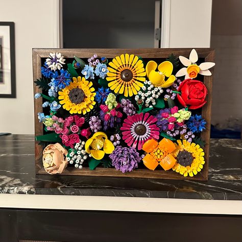 Lego flower shadow box frame with dark walnut stain Lego Wall Decorations, Vases For Lego Flowers, Lego Botanical Display, Lego Flower Wall Display, Lego Flower Ideas, Lego Wedding Flowers, How To Display Lego Flowers, Lego Flower Display Ideas, Lego Succulent Display