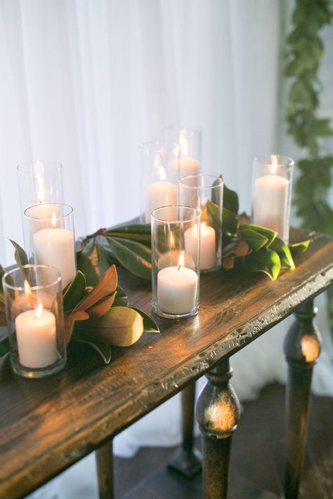 Decor With Magnolia Leaves, Magnolia Leaf Centerpiece, Magnolia Greenery Wedding, Magnolia Themed Party, Magnolia Centerpiece Wedding, Candle Arrangements Wedding, Winter Magnolia Wedding, Magnolia Flower Wedding Decor, Magnolia Garland Wedding Table