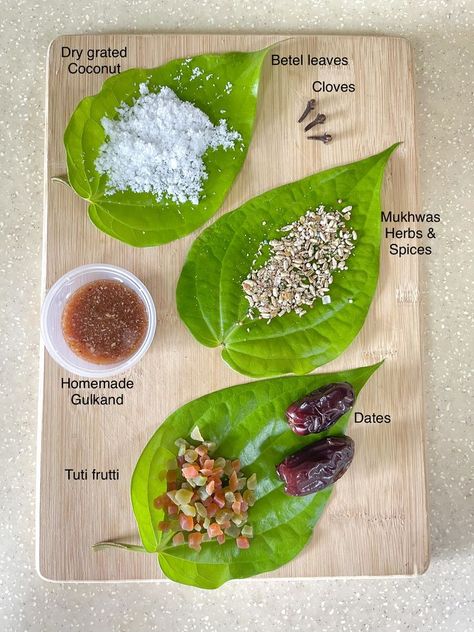 Ingredients - Betel leaf,Dry grated coconut,Cloves,Homemade Gulkand,Mukhwas Herbs & Spices,Tuti Frutti & Dates. Method - 1. Betel leaf -Wash,Pat dry,remove stalk 2. leaf facing down -place all the ingredients on the leaf 3. roll the edge of leaf & make pouch shape-keep all filled items inside 4. fold the leaf & insert clove to seal it. Done! Betel Leaf, Indian Cooking Recipes, Grated Coconut, Indian Cooking, Plastic Free, Dates, Beauty Hacks, Coconut, Cooking Recipes