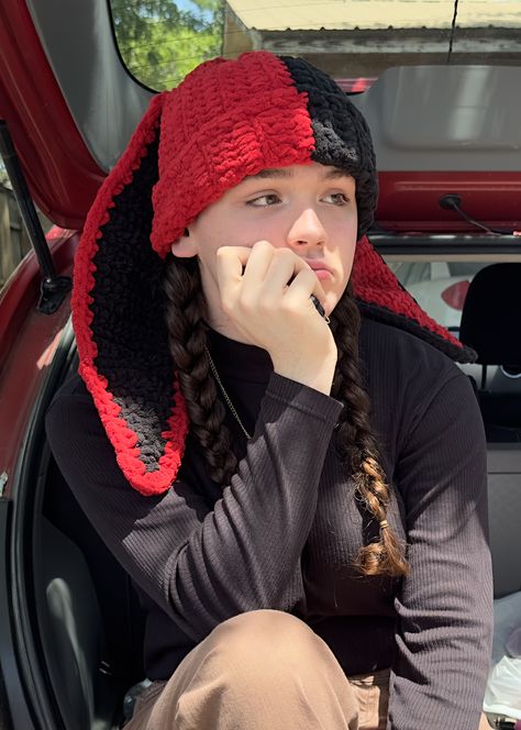 Red and black crochet bunny beanie. Color is split down the middle and both ears are a different color. Bunny Eared Beanie, Crochet Beanie Bunny Ears, Bunny Ears Crochet Hat, Crochet Beanie Bunny, Fluffy Beanie Crochet, Crochet Beanie With Design, Crochet Beanie With Ears, Bunny Ear Beanie Crochet, Bunny Beanie Crochet Pattern