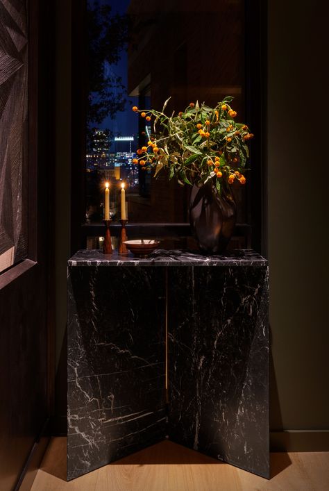 Entryway showcases a black marble console table, floral arrangement, and city skyline views. The dark, sophisticated atmosphere is perfect for a bi-coastal couple. Marble Console Table Entryway, Black Marble Console, Austin Interior Design, St Cecilia, Console Table Entryway, Table Entryway, Marble Console Table, Marble Console, Skyline View