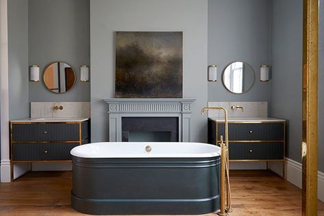 The ensuite bathroom, on the other hand, feels luxe and opulent, with reeded glass, fluted cabinetry, brass and marble. [Photographer: Anna Stathaki | Designer: Finkernagel Ross] Blue Bathtub, Gray Bathroom Vanity, Bathroom Vanity Ideas, Grey Bathroom Vanity, Gray Bathroom, Standing Bath, Vanity Ideas, Herringbone Floor, Classic Bathroom