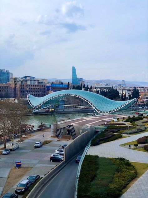 Bridge of Peace, pedestrian bridge across Kura River | Tbilisi, Republic of Georgia | Designed by Italian architect Michele De Lucchi | Opened 2010 | 150 meters/1/10th mile long Bridge Of Peace Tbilisi, River Bridge Design, Meditation Hall, City Infrastructure, Peace Bridge, Infrastructure Design, Republic Of Georgia, Kitchen Shower, Wedding Invitation Video