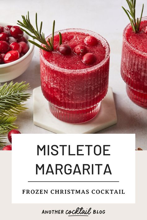 Made with a combination of cranberry and pomegranate, and sweetened with rosemary simple syrup, these frozen mistletoe margaritas are a festive twist on the classic margarita. Garnish with a sugared rim, fresh rosemary and cranberries to create a Christmas margarita worth of your holiday celebrations. Frozen Cranberry Margarita, Frozen Christmas Cocktails, Margarita Garnish, Mistletoe Margaritas, Mistletoe Margarita, Tequila And Lemonade, Christmas Margarita, Frozen Watermelon Margarita, Cranberry Pomegranate