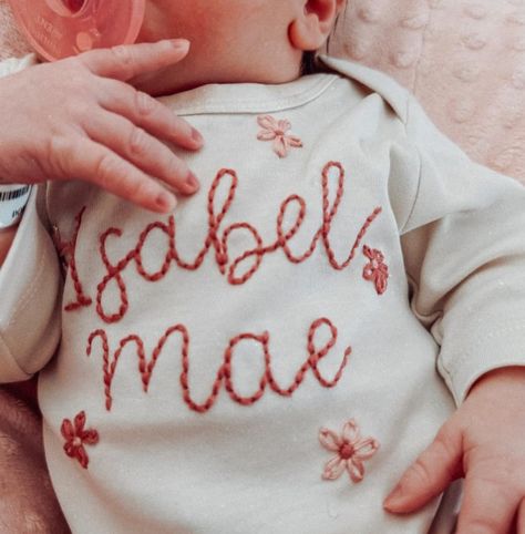 Tiny baby hands in a tiny baby onesie covered with tiny baby flowers. Can this be any cuter?! Welcome to the world miss Isabel Mae! #newbornonesie #handembroideredonesie #customembroidery #newbornphotography Embroidered Baby Onesie, Onesie Embroidery, Embroidered Onesie, Newborn Onesies, Baby Flower, Hand Embroidery Projects, Embroidery On Clothes, Baby Hands, Embroidery Ideas