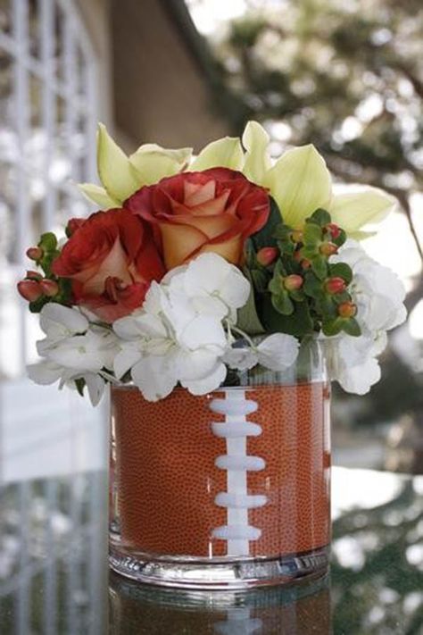 football centerpieces for tables | We really love this clear vase football centerpiece and the lovely ... Football Party Centerpieces, Baby Shower Centerpieces For Boys, Football Centerpiece, Football Centerpieces, Banquet Centerpieces, Grooms Table, Football Banquet, Football Wedding, Sports Banquet