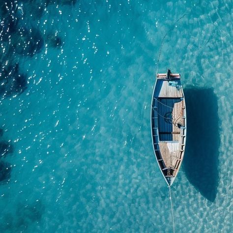 From above, a fisherman’s boat drifts in a sea of mesmerizing azure—a visual ode to the boundless embrace of cerulean waves, where maritime simplicity meets the vastness of a poetic horizon. #fishinglife #fishingboat #boat #sealife #sealovers #sealover #seashore #blue #blusea #seainspired Boat From Above, Sea From Above, Sea Lover, Sea Inspired, Fishing Life, Sealife, A Sea, Yachts, Fishing Boats