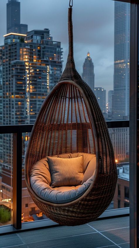 Rattan hanging chair overlooking city lights, a serene escape above the bustling metropolis. Perfect spot for relaxation and contemplation. City View, Hanging Chair, Cityscape