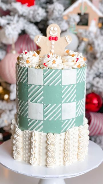 C R Y S T A L | CAKE DESIGNER on Instagram: "Sweater + plaid cake 🎄 . Hands downs, obsesseeeeeeddd! When I first had this idea in mind, in knew it had to be a soft GREEN! So festive! . White plaid on a green buttercream base, made with a stencil! Bordered with sweater-like knitting using different piping tips and stable white buttercream. Topped off with the most adorable Christmas sprinkles with mini gingie men and candy canes, mini branches, and the cutest gingerbread man cookie! . Going back to a few Christmases ago and forever obsessed 🎄 . #trending #reels" Different Piping Tips, Plaid Cake, Green Buttercream, White Buttercream, Christmas Sprinkles, Gingerbread Man Cookies, Trending Reels, Piping Tips, Candy Canes