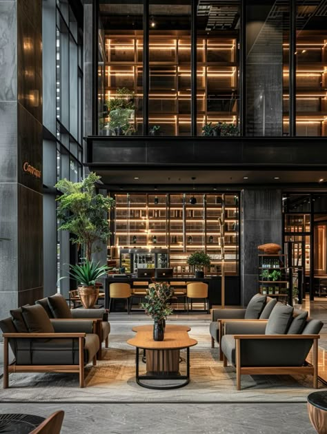 The hotel lobby is designed in a dark gray Hotel Lobby Restaurant, Dark Lobby Design, Industrial Hotel Design, Moody Hotel Lobby, Industrial Hotel Lobby, Luxury Hotel Lobby Lounge, Apartment Lobby Interior Design, Hotel Entrance Design, Skyscraper House