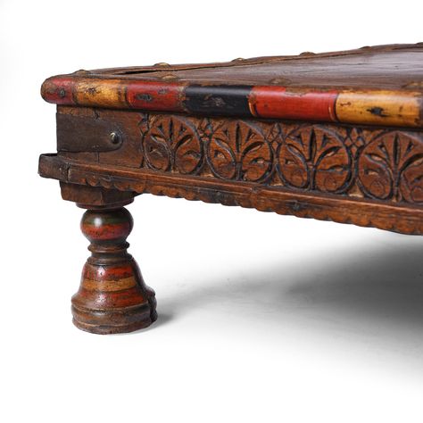 This antique Indian bajot low table is a lovely little example of the style dating to the 19th century. It is from Shekhawati in Rajasthan and would have been multifunctional, used for day to day dining and also for displaying leisure paraphernalia such as opium or writing equipment. It is made from roheda wood. 
Shekhawati bajots like this one commonly have lacquered beading which makes them more attractive than many. There is also delicate carving on the sides. The turned legs are also lacquered. Bajots are found in many styles around India. 
UK Delivery Charge - except Highlands & Islands £15More delivery options available at checkout Low Table, Turned Leg, Low Tables, Teak Wood, End Tables, 19th Century, Teak, Beading, Carving