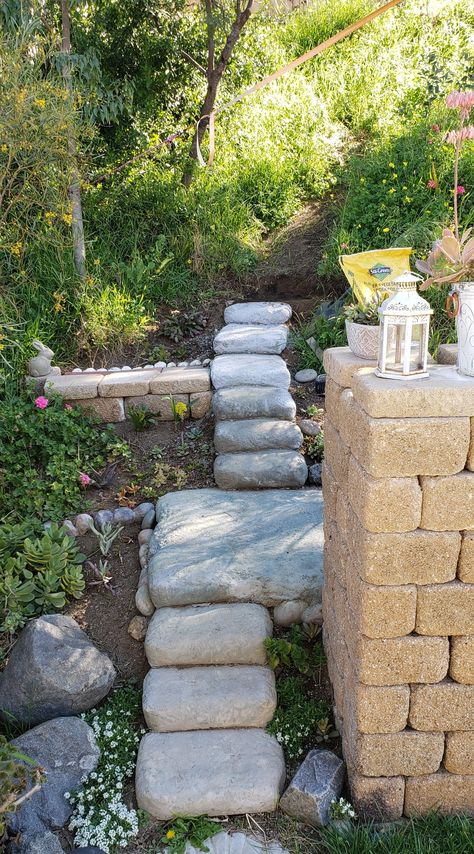 I have 10 cement bag steps done, many more to go. The process is to place the bags, each one slightly overlapping the other. Make sure every part of the bag is supported, or it will crack when drying. Roll the bags around a bit first to distribute the mix. Then make some slices in the bag to allow water in more freely, & sprinkle on about a gallon per bag. Rewet every couple hours. Next day, you can peel off the paper. There will probably be loose spots & cracks-- fix with cement patch. Cement Bag Walkway, Concrete Bags Ideas, Earth Bag Retaining Wall, Concrete Bag Steps, Concrete In Bags Pathway, Cement Bags Ideas, Cement Bag Retaining Wall, Plastic Bag Concrete Rocks, Cement Stones Plastic Bag Diy