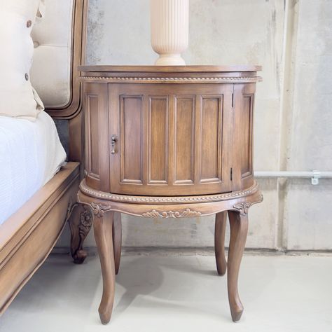 The Coquette Bedside Table features a charming circular profile, delicate beaded carvings, and botanical details in a unique finish. Perfect for any room, it offers a spacious top for display and a cubby for storage. Antique pull hardware and a distressed finish complete its timeless look. #frenchstyledecor #frenchcountry #sydneyinteriorstyling French Style Decor, Vintage Bedside Table, Cubbies, Bedside Table, French Country, Interior Styling, Carving, Quick Saves