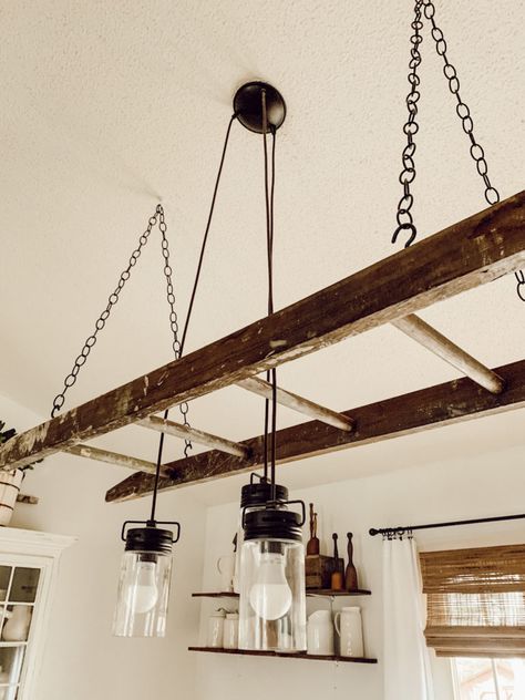 DIY Ladder Chandelier | Showit Blog Old Ladder Hanging From Ceiling, Diy Ladder Light Fixture, Ladder Ceiling Decor, Ladder Lights Hanging, Hanging Ladder From Ceiling, Hanging Ladder Decor, House Warming Decoration Ideas, Ladder Ceiling, Ladder Light Fixture