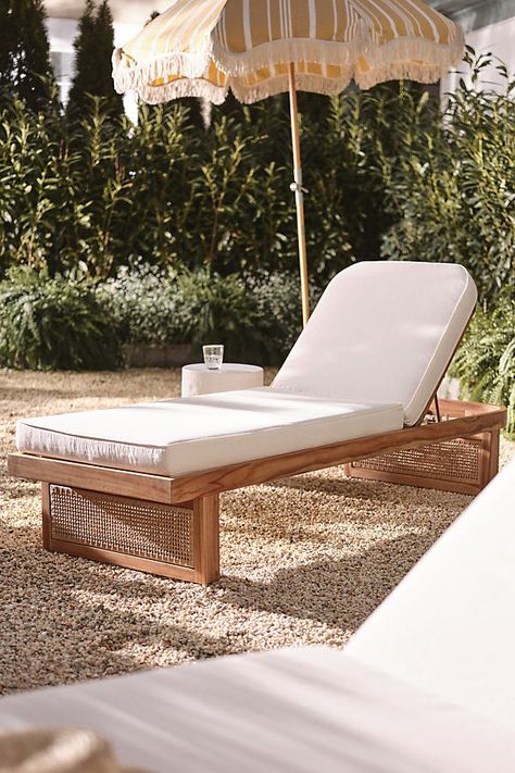 Coated in a UV- and water-resistant fabric, this lounge chaise was made for dreamy warm-weather days. A soft cushioned seat rests atop a natural teak wood base, finished with intricate rattan-esque paneling. For ordering assistance and more, please contact us For aesthetic advice and tips to help decorate your space, enjoy our complimentary home styling services | Merit Chaise Lounge by Anthropologie in Beige Lounge Chaise, Teak Chaise Lounge, Pool Lounge Chairs, Useful Ideas, Pool Chairs, Natural Teak Wood, Deck Designs Backyard, Chaise Chair, Outdoor Lounge Chair