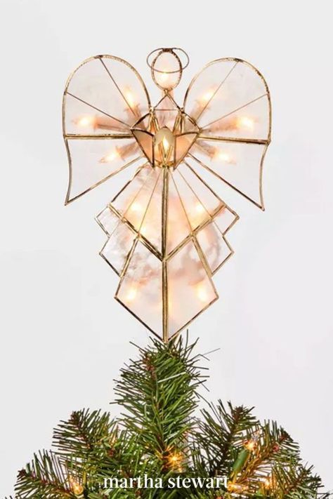 An angel earns her wings as the topper of any Christmas tree. This modern topper—with 16 white lights—adds even more excitement to your holiday display. It's composed of clear capiz shells framed inside a gold metal trim for pretty ornamental flair. #christmas #holidayideas #christmasideas #wintertodo #marthastewart Light Up Angel Tree Topper, Modern Angel Tree Topper, Glass Angel Tree Topper, Angel On Christmas Tree, Diy Christmas Tree Topper Angel, Christmas Tree Toppers Angel, Stained Glass Angel Tree Topper, Cross Tree Topper, Angel Topper Christmas Tree