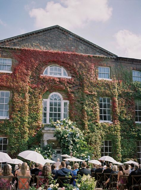 Outdoor wedding ceremony at Wootton Hall, with guests shielding themselves from the sunshine under white wedding parasols. Elegant bride in a Suzanne Neville wedding dress with high lace neck, long lace sleeves and large bow at the back. Katie Julia Photography. Suzanne Neville Wedding Dresses, Personal Vows, Parasol Wedding, Floral Archway, Suzanne Neville, Wedding Cinematography, Bespoke Wedding Dress, Lace Neck, Church Ceremony