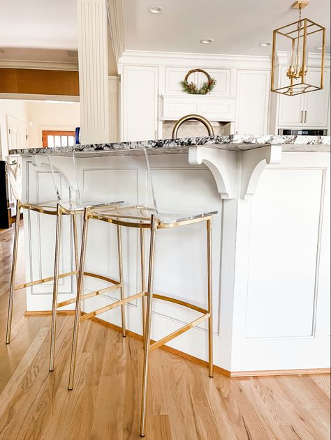 White kitchen, clear acrylic seat barstools with gold legs. Low back Clear Barstools In Kitchen, Ghost Bar Stools, Cute Barstools Kitchen Stools, Barstools Apartment, Aesthetic Barstools, Apartment Barstools, Kid Friendly Bar Stools, Cute Barstools, Kitchen Island With Bar Stools