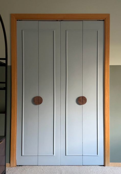 Learn how to give an old folding door a new completely new modern look with this DIY Closet Doors under $50 post!  A fresh coat of paint, adding some decorative trim molding and modern circular doorknob hardware gives your closet a fresh budget friendly feel.  Delineate Your Dwelling Painting Folding Closet Doors, Flat Panel Closet Door Makeover, Update Bifold Louvered Closet Doors, Diy Closet Door Upgrade, Large Bifold Closet Doors, Plain Closet Door Makeover, Closet Door Molding, How To Install Closet Doors, Installing Closet Doors