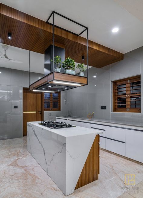 An Elegant Home that Weaves Emotions with Works of Art | P Square Designs - The Architects Diary Kitchen Interior Tiles Design, Work Kitchen Ideas, Center Kitchen Design, Unique Modern Kitchen, Square Kitchen Layout, Kitchen Tiles Wall, Island Kitchen Design, Modern Kitchen Room, Kitchen Wall Tiles Design