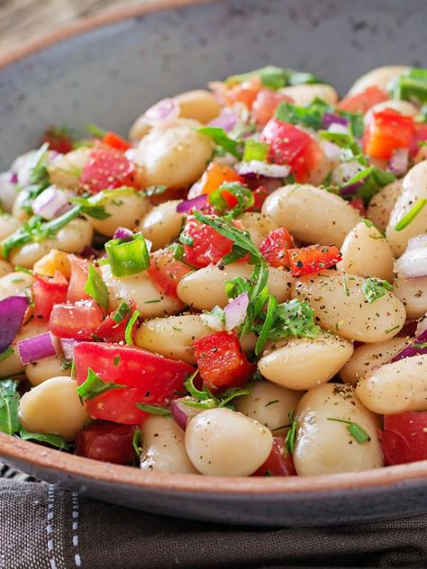 Do you want to try the best Warm Spanish Bean Salad Recipe? The white bean salad is the perfect winter salad for it's also nutritious and healthy but it's also a warm salad. This Spanish white bean salad is incredibly easy to make, requires few ingredients and it's very low-fat, so it's a great choice while you're on a diet. So if Spanish traditional salad recipes you're after, don't hesitate to try the comforting Spanish bean salad. #spanishbeansalad #beansalad #warmbeansalad #spanishsalads Lima Bean Salad Cold, Spanish Fruit Salad, Spanish Salad Recipes, Spanish Salads, Spanish Meal, Bean Salad Recipes Healthy, Spanish Salad, Spanish Beans, White Bean Salad Recipes