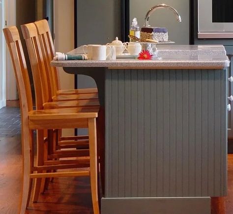 How Strips of Wood Can Enhance Your Kitchen Designs – VESTABUL SCHOOL OF DESIGN Wood Veneer Kitchen Island, Slated Wood Island, Beadboard Island Kitchen, Kitchen Island Slatted Wood, Reeded Wood Kitchen Island, Adding Bead Board To Kitchen Island, Stained Beadboard, Classic Backsplash, Stained Shiplap